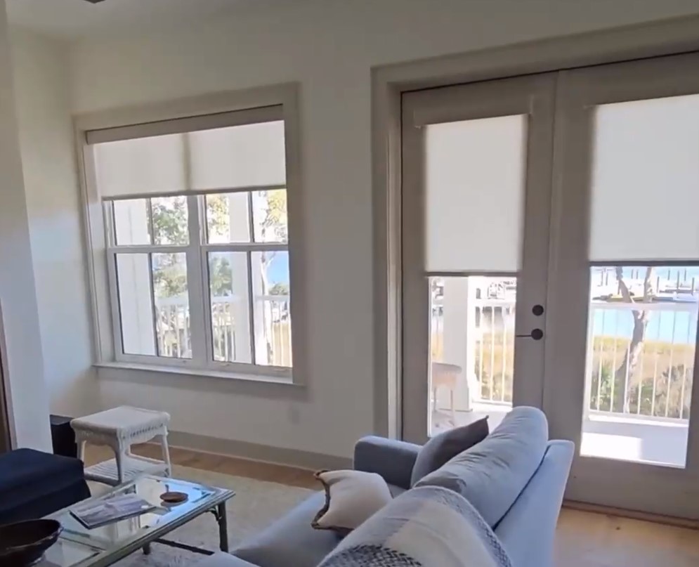 sheer shades being lowered using motorization in home